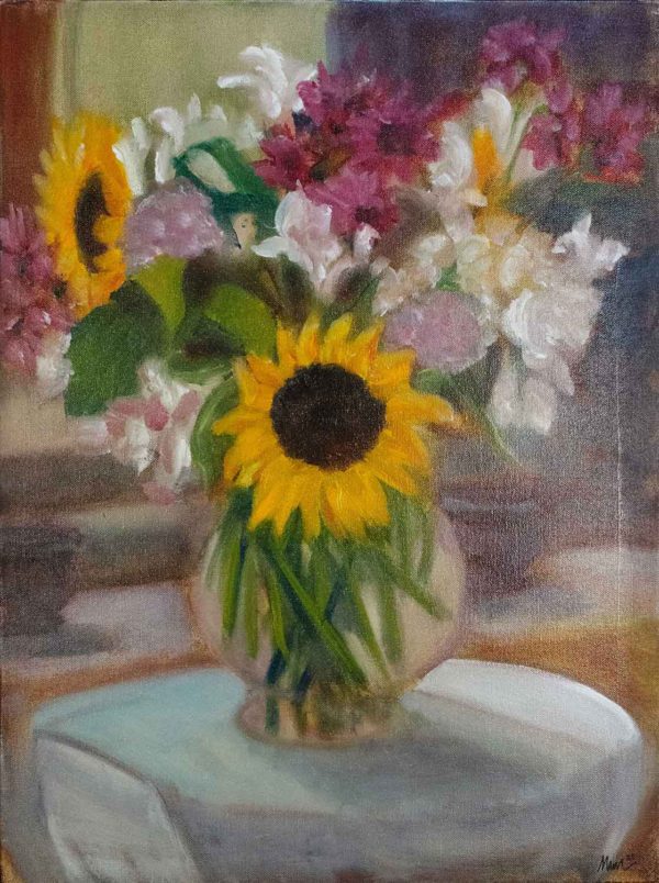 A vase of flowers set on a table outside, with a sunflower in the center, reminding me of a child say "Look At Me!"