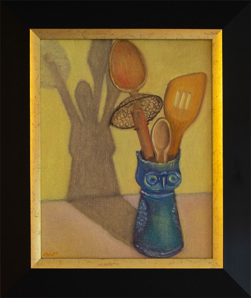 A blue owl-shaped vase holds cooking utensils, casting a shadow on a yellow counter and wall.