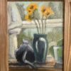 A black cat seated watching wildlife out the window, next to a blue vase with yellow flowers