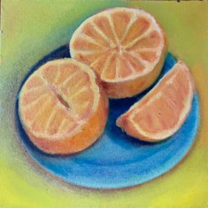 Cut oranges on a bright blue plate